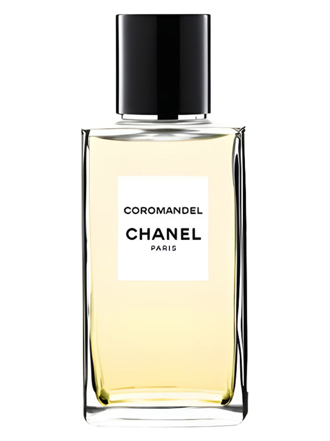 A decanted portion of Les Exclusifs de Chanel Coromandel Eau de Parfum stored in a sleek clear atomizer with a label, photographed against a clean white background.
