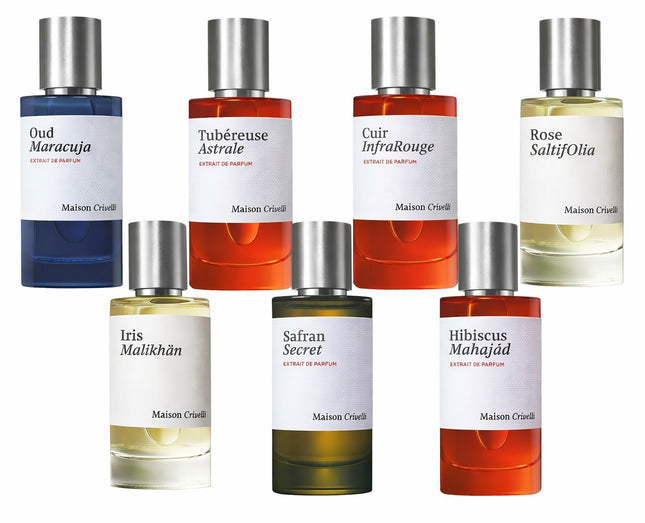 Collection of Maison Cruse perfume bottles with various colored labels on a white background