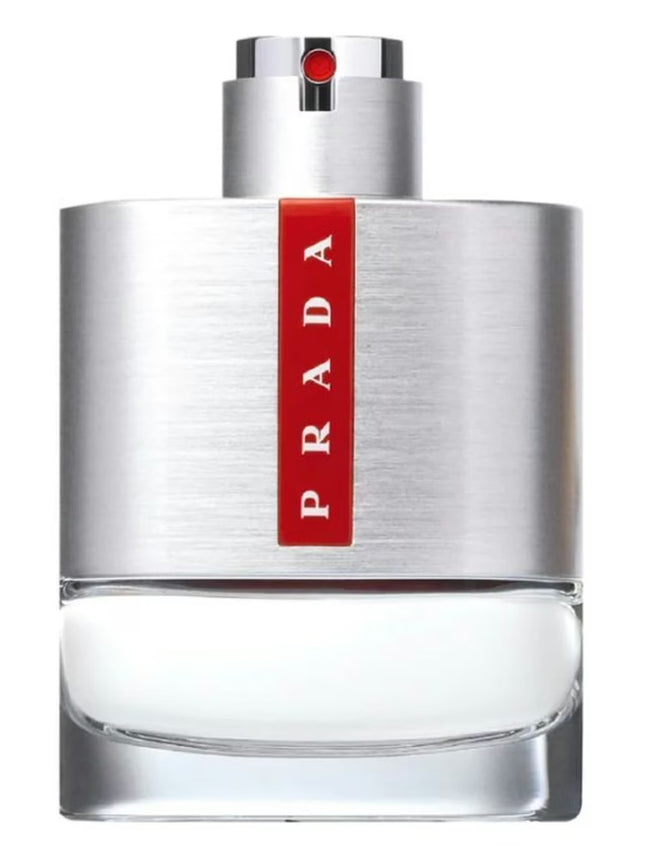 Prada perfume bottle with silver cap and red label on a white background