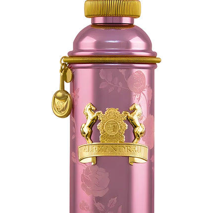 Pink perfume bottle with gold accents on a white background