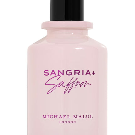 Pink perfume bottle with black cap labeled 'Sangria + Saffron' by Mich ael Malulon a white background