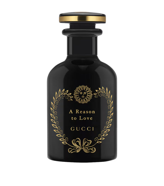 Black Gucci perfume bottle with gold accents on a white background